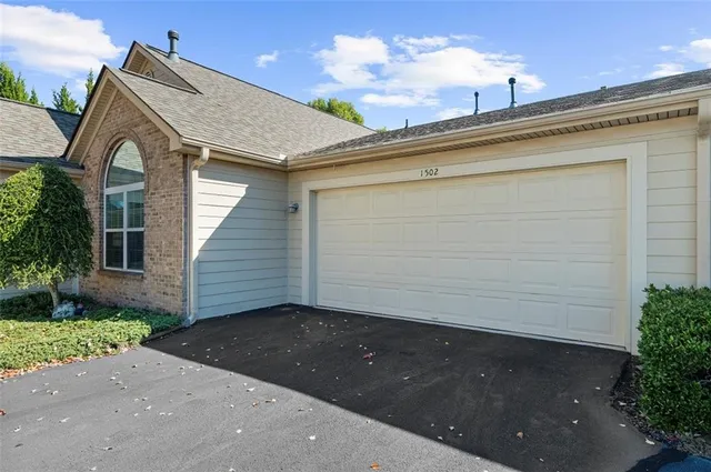 a front view of a house with a garage
