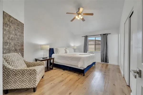 a spacious bedroom with a bed and a couch