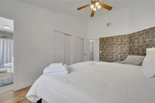 a bedroom with a bed and a chandelier