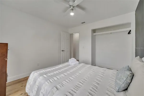 a bedroom with a bed and a ceiling fan