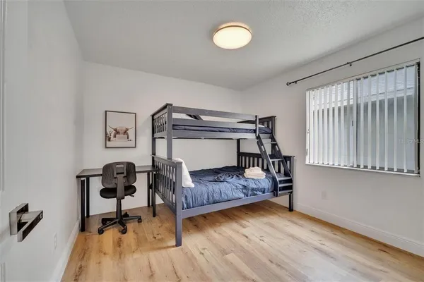 a bedroom with furniture and a wooden floor
