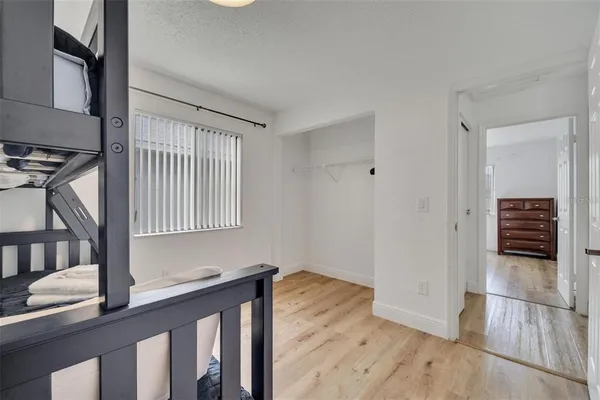 a view of a livingroom with wooden floor and staircase