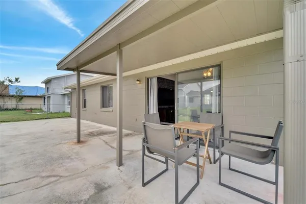 a view of a patio with table and chairs and potted plants