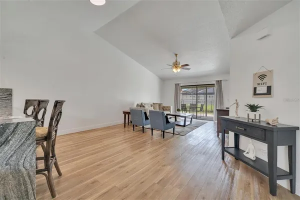 a living room with furniture and wooden floor