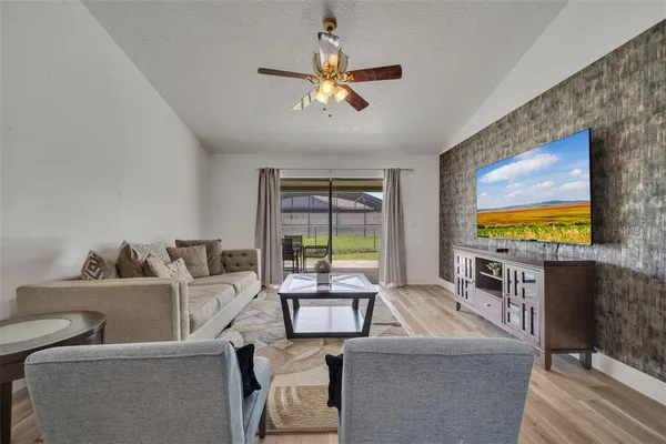 a living room with fireplace furniture and a flat screen tv