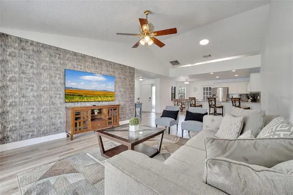 a living room with furniture and ceiling fan