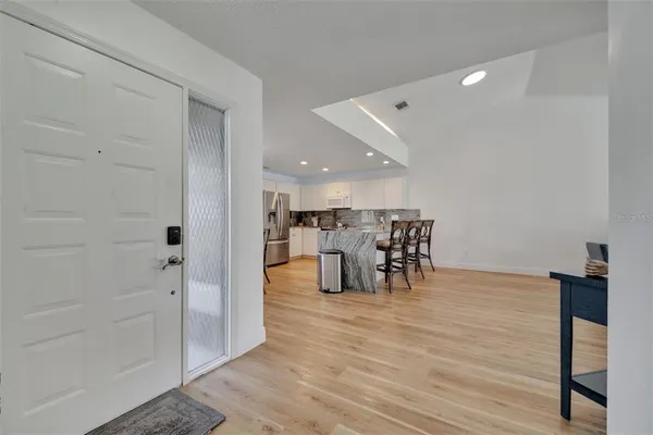 a view of a room with wooden floor