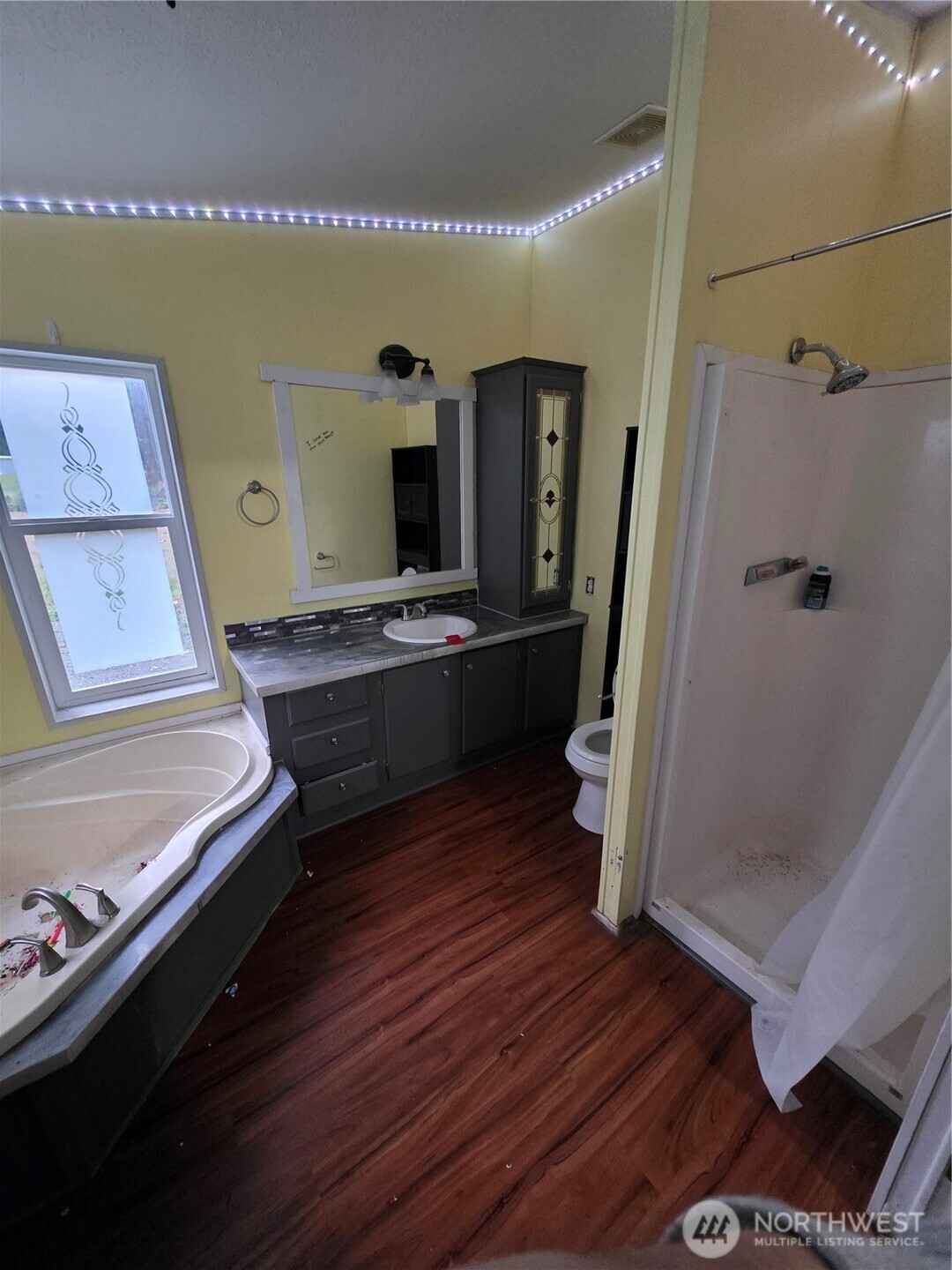 1104 East Alderwood Road Belfair, WA 98528 - Photo 11 of 15 a living room with hard wood floors and a fireplace