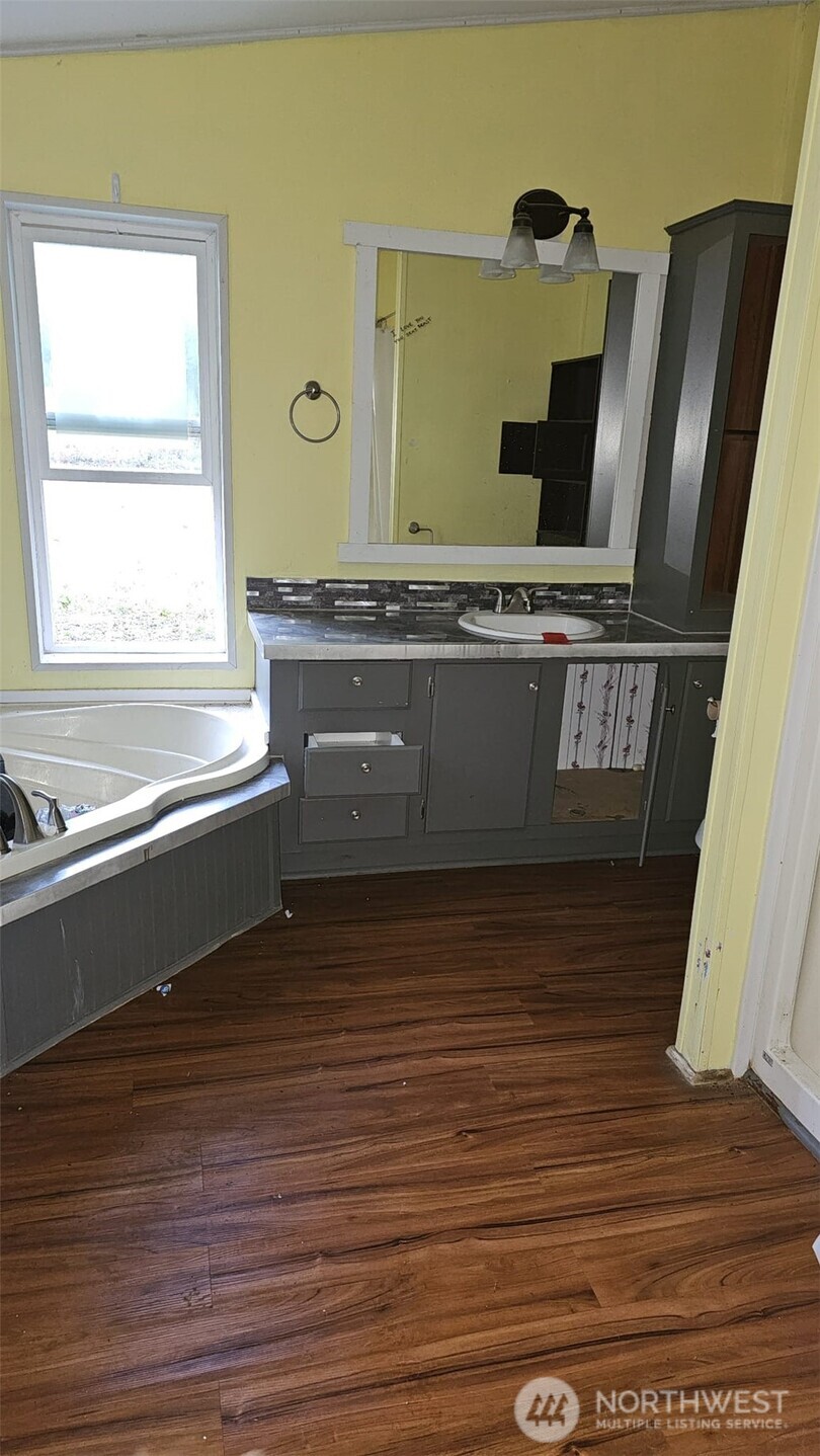 1104 East Alderwood Road Belfair, WA 98528 - Photo 12 of 15 a view of a refrigerator a sink and a window