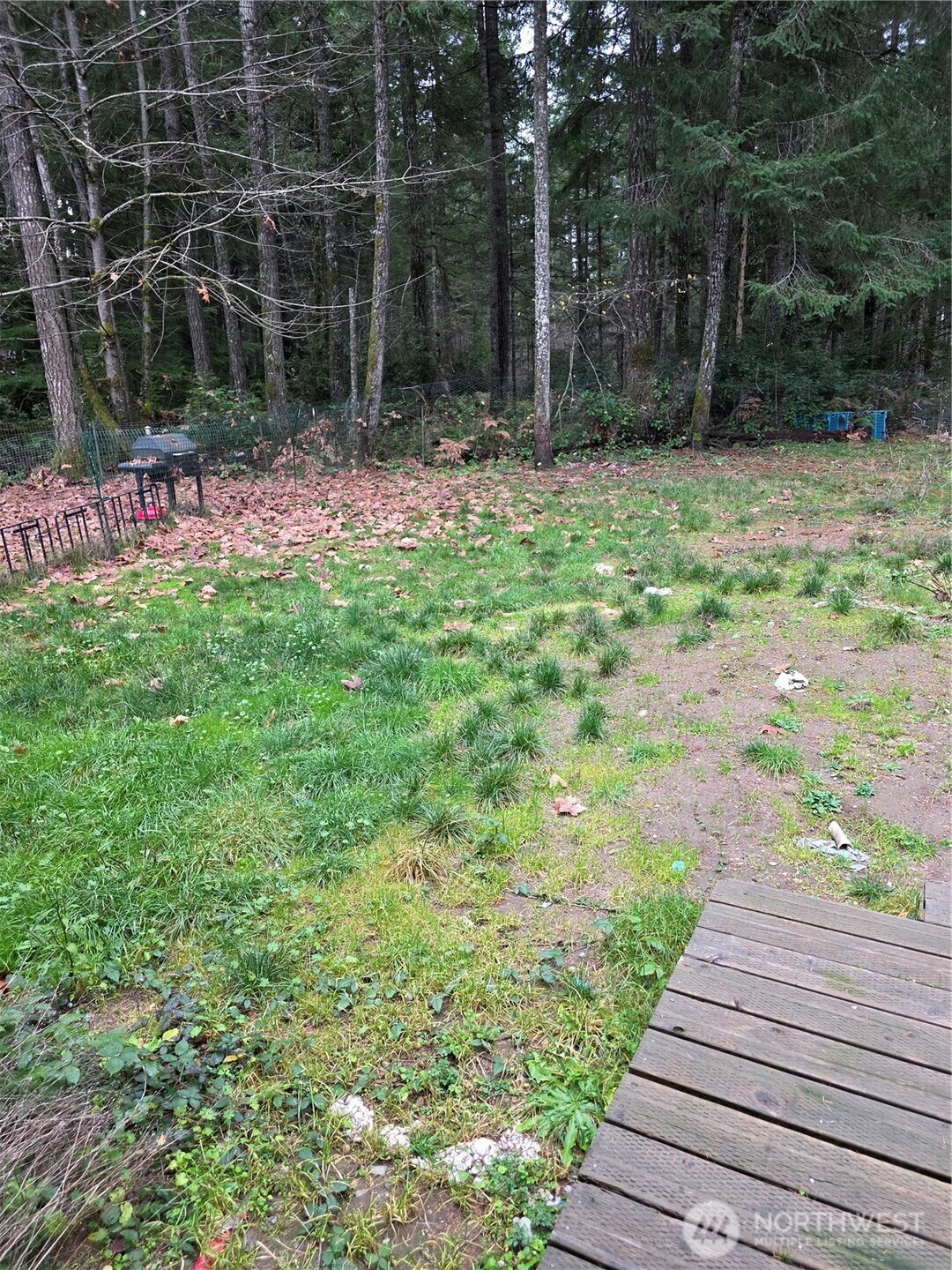 1104 East Alderwood Road Belfair, WA 98528 - Photo 14 of 15 a backyard of a house with table and chairs