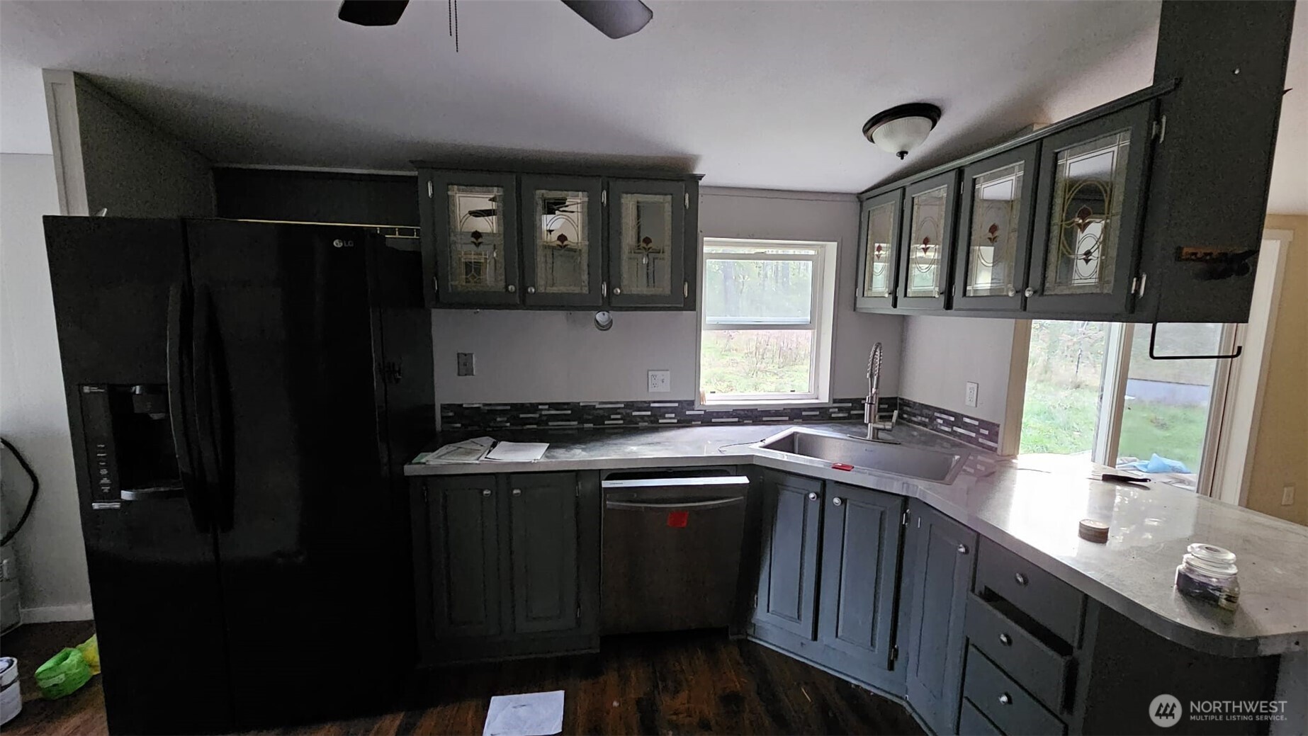 1104 East Alderwood Road Belfair, WA 98528 - Photo 6 of 15 a kitchen with stainless steel appliances granite countertop a refrigerator a sink a stove and wooden floors