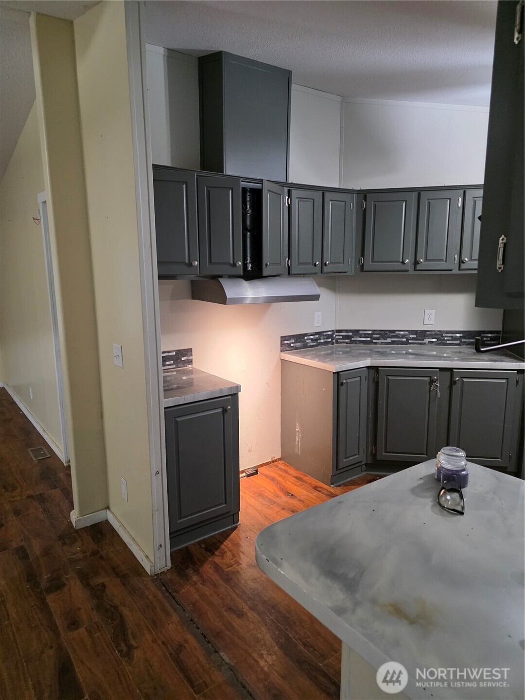 1104 East Alderwood Road Belfair, WA 98528 - Photo 7 of 15 a kitchen with kitchen island granite countertop wooden cabinets and a sink