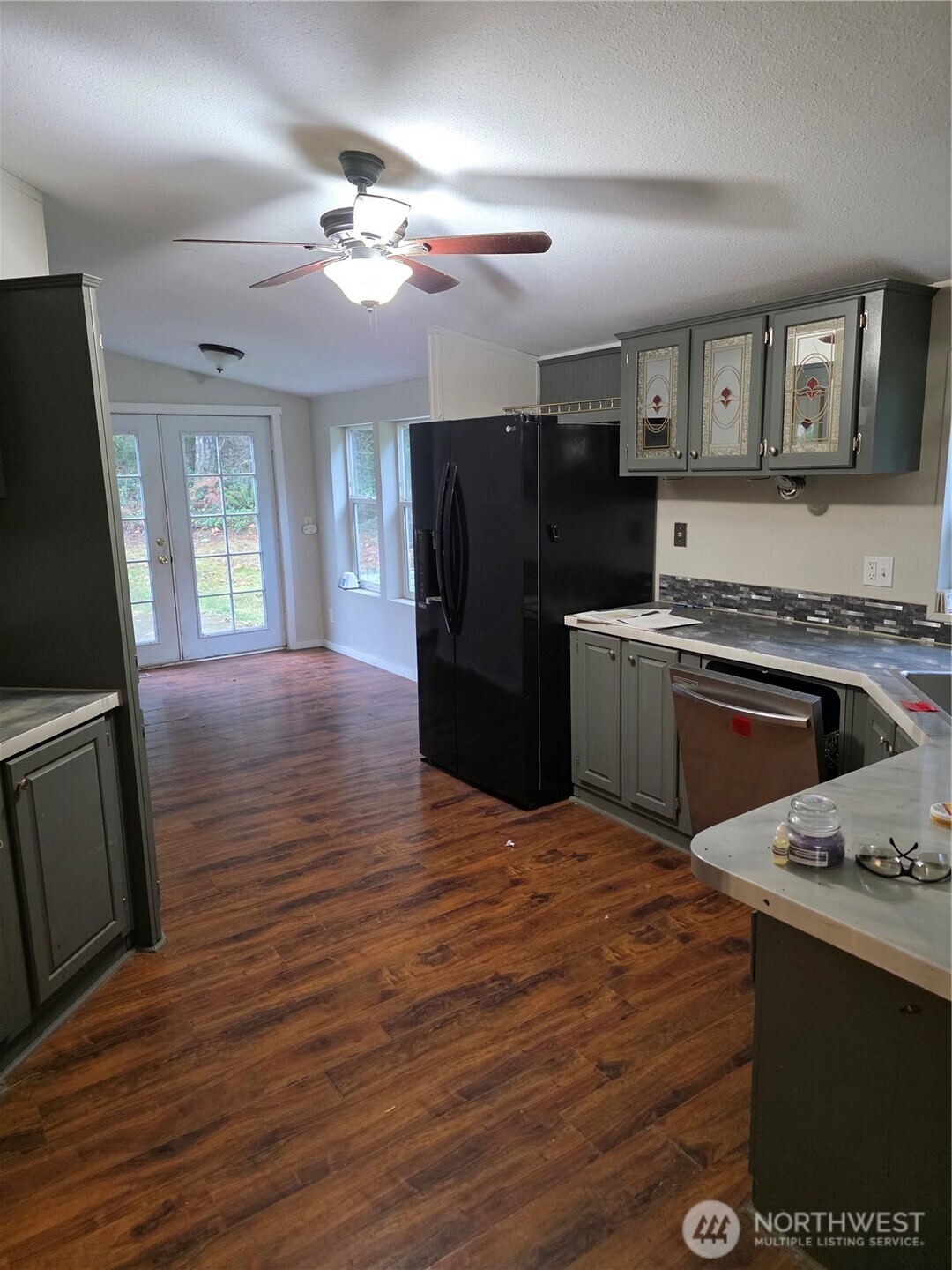 1104 East Alderwood Road Belfair, WA 98528 - Photo 8 of 15 a kitchen with a stove a refrigerator and a fireplace