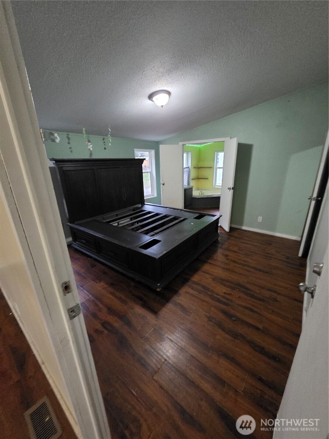 1104 East Alderwood Road Belfair, WA 98528 - Photo 10 of 15 a living room with furniture flat screen tv and a wooden floor