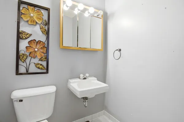 a bathroom with a sink mirror and vanity