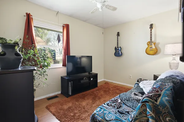 a bedroom with a bed and a flat screen tv