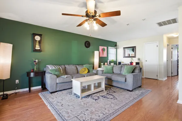 a living room with furniture and a flat screen tv