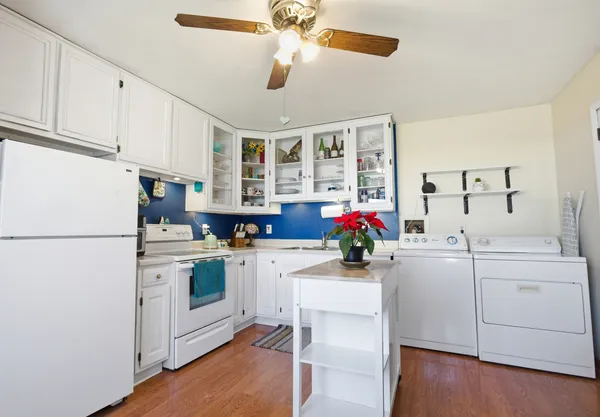 a kitchen with a white cabinets and white appliances