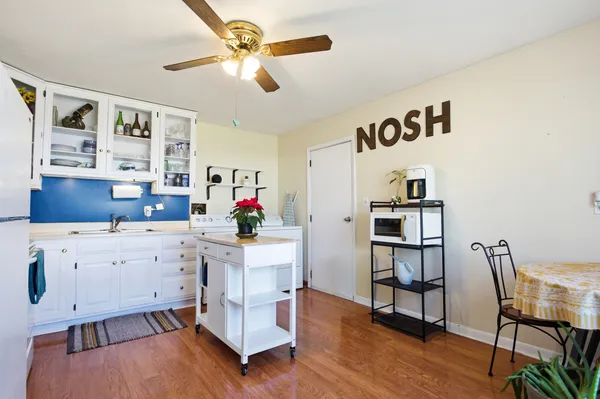 a view of kitchen with cabinets and wooden floor