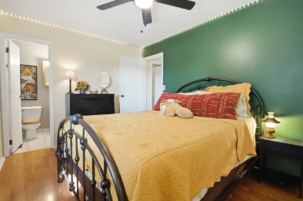 a bedroom with a bed and wooden floor