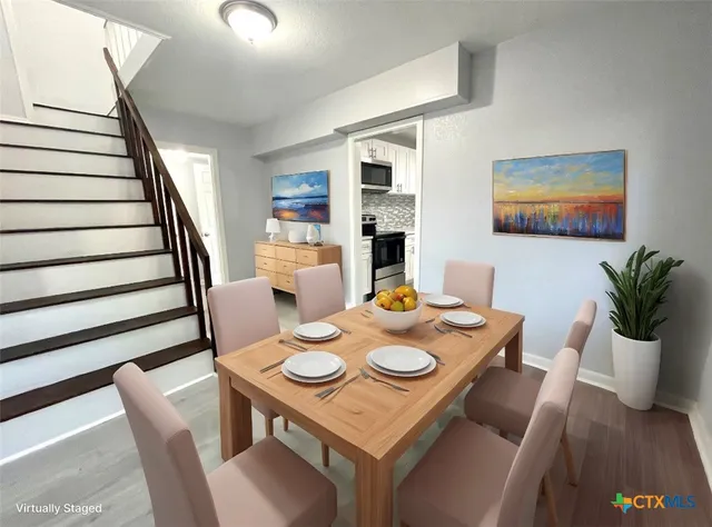 a view of a dining room with furniture and wooden floor