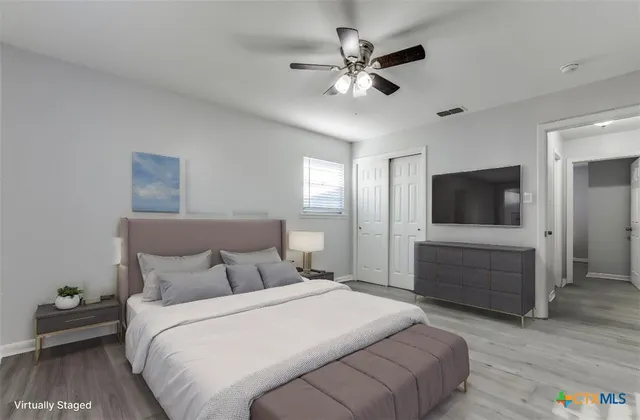 a bedroom with a bed and a flat screen tv