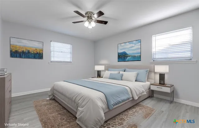 a bedroom with a bed and a painting on the wall