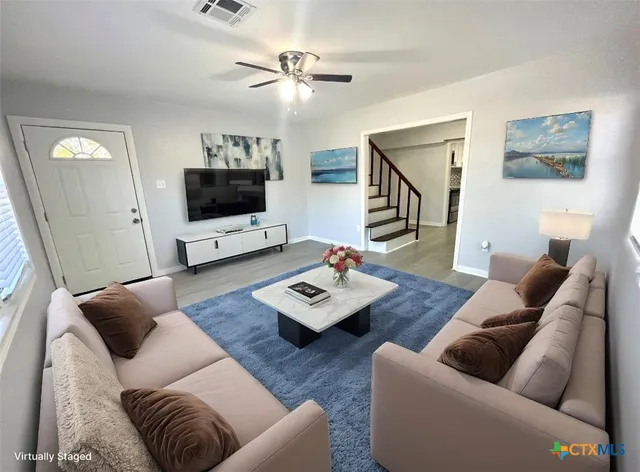 a living room with furniture and a flat screen tv