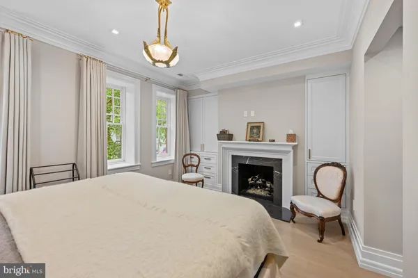 a bedroom with bed and a fireplace