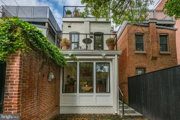 a view of a white house with a large windows