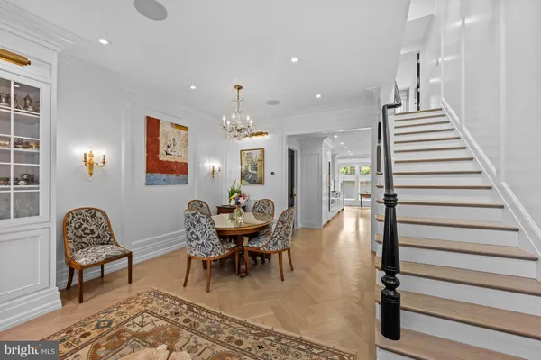 a dining room with furniture and wooden floor