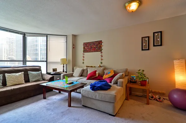 a living room with furniture and a potted plant
