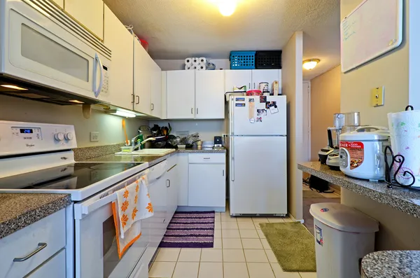 a kitchen with a refrigerator and cabinets