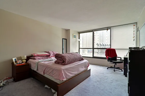 a bedroom with a bed and a desk