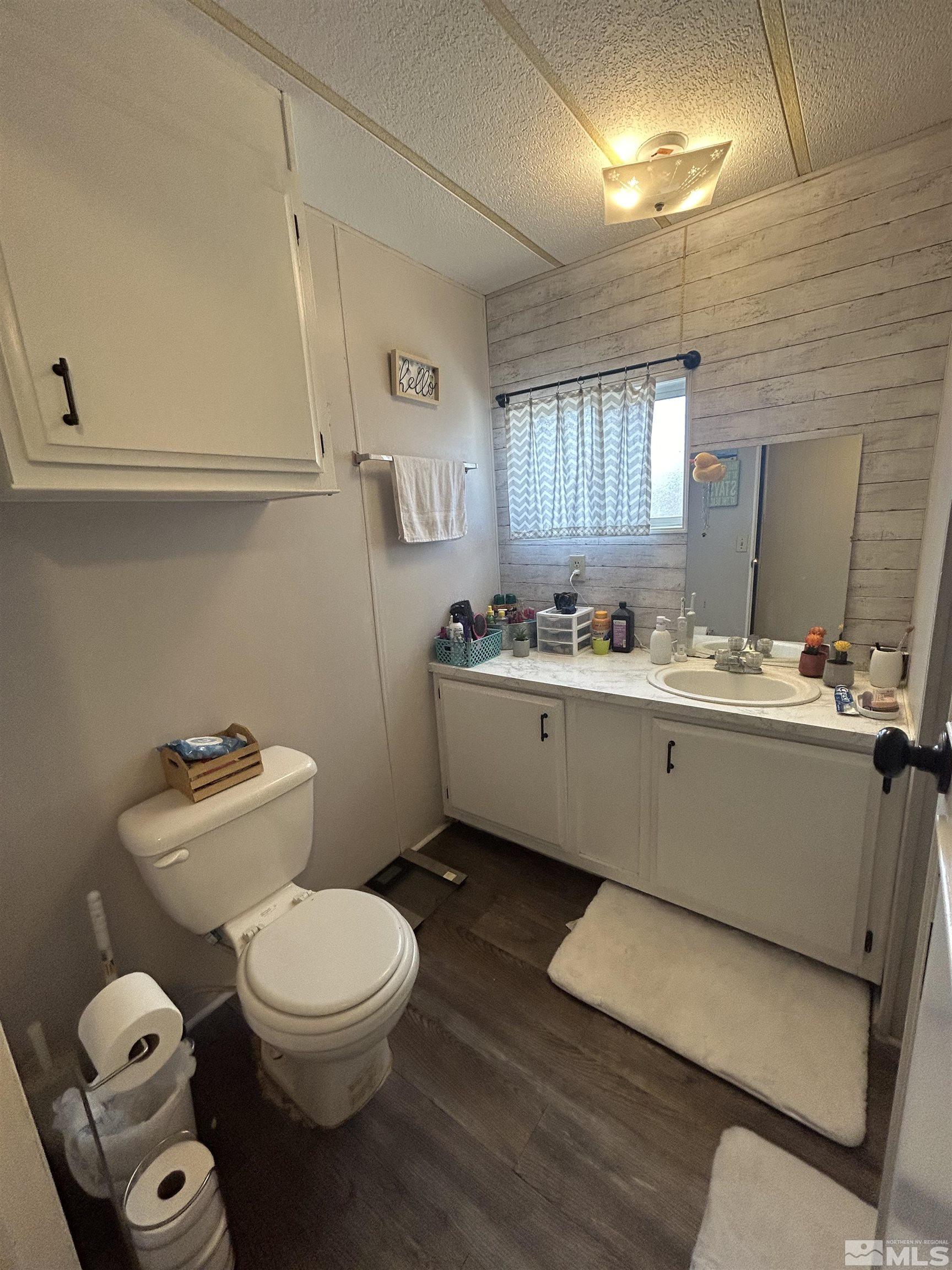 212 Coons Circle, Unit E Dayton, NV 89403 - Photo 14 of 20 a bathroom with a toilet sink and mirror