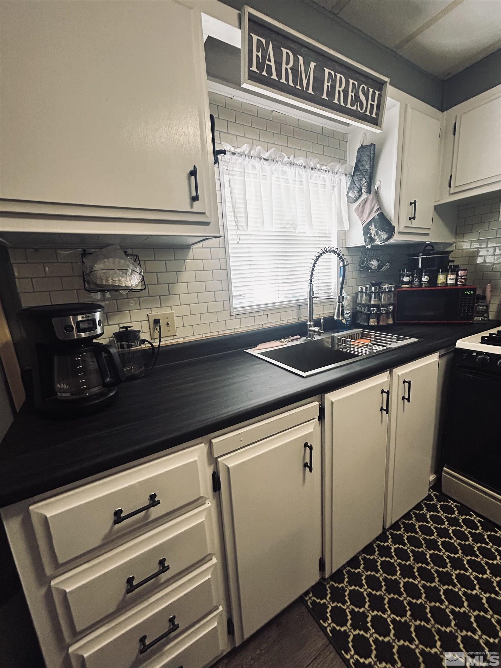 212 Coons Circle, Unit E Dayton, NV 89403 - Photo 6 of 20 a kitchen with a sink and cabinets