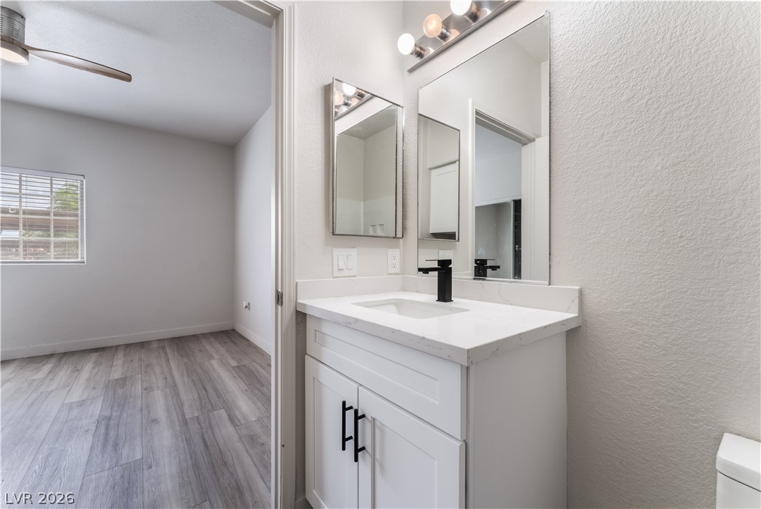 4730 East Craig Road, Unit 1058 Las Vegas, NV 89115 - Photo 19 of 30 A sleek white vanity with a black faucet anchors this bright and functional bathroom space.