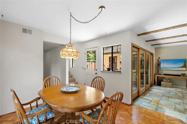 a spacious bedroom with a bed and a chandelier