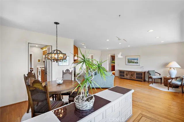a living room with couch floor to ceiling window and a flat screen tv