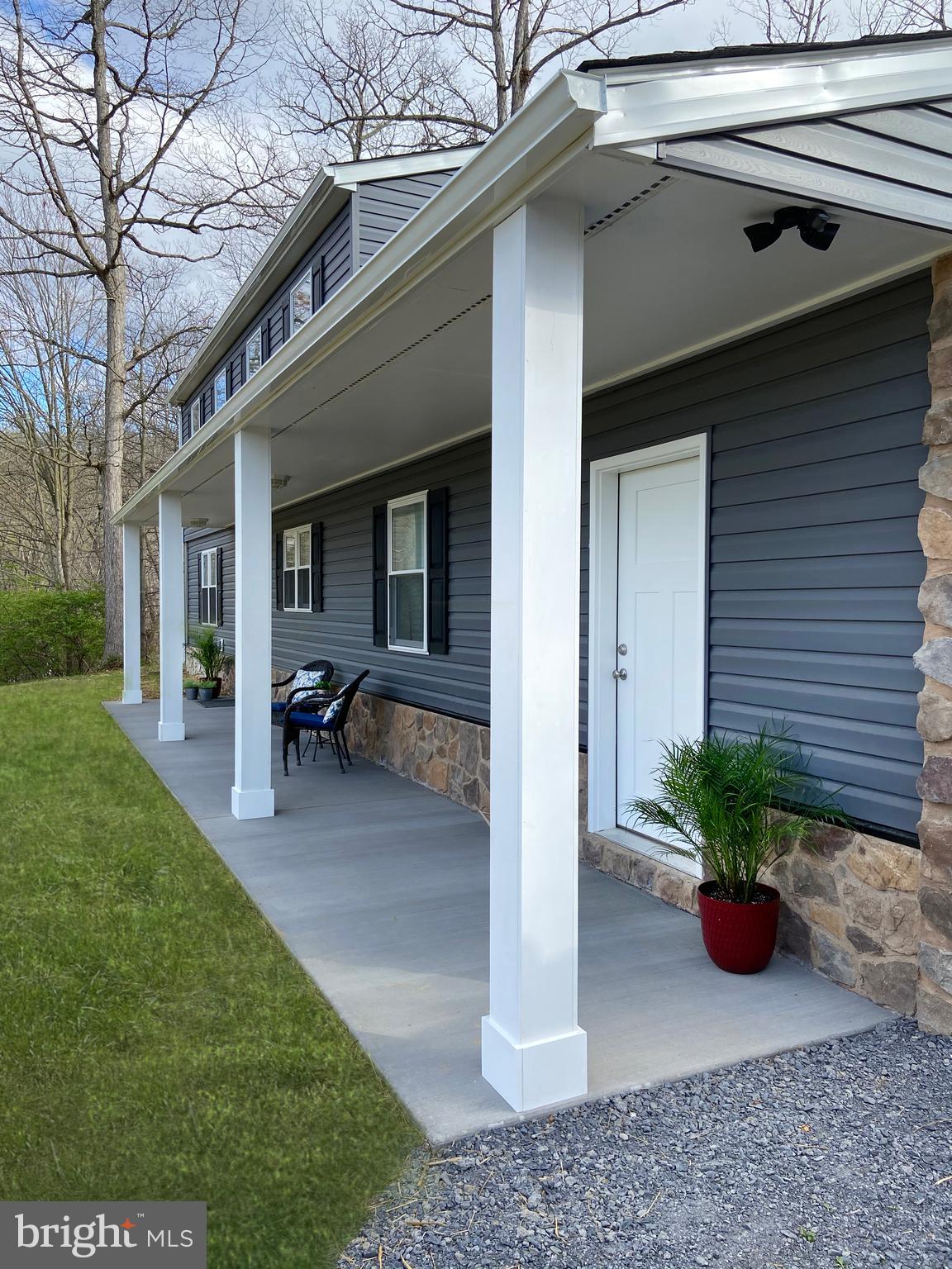 3797 Howellsville Road Front Royal, VA 22630 - Photo 4 of 66 a view of a house with a yard potted plants and a table and chair