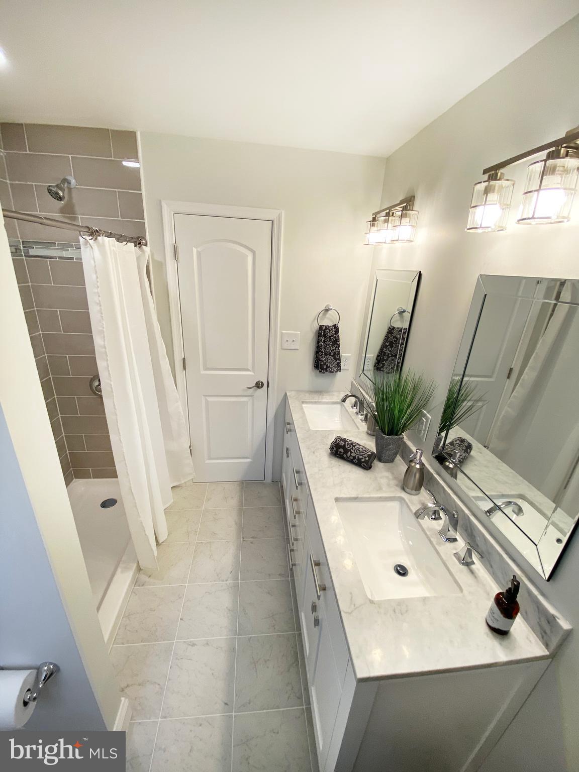 3797 Howellsville Road Front Royal, VA 22630 - Photo 36 of 66 a bathroom with a sink a mirror and a shower