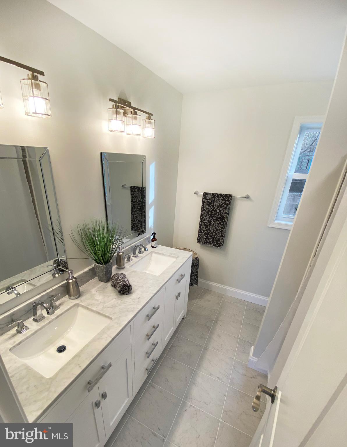 3797 Howellsville Road Front Royal, VA 22630 - Photo 37 of 66 a bathroom with a double vanity sink and mirror with bathtub