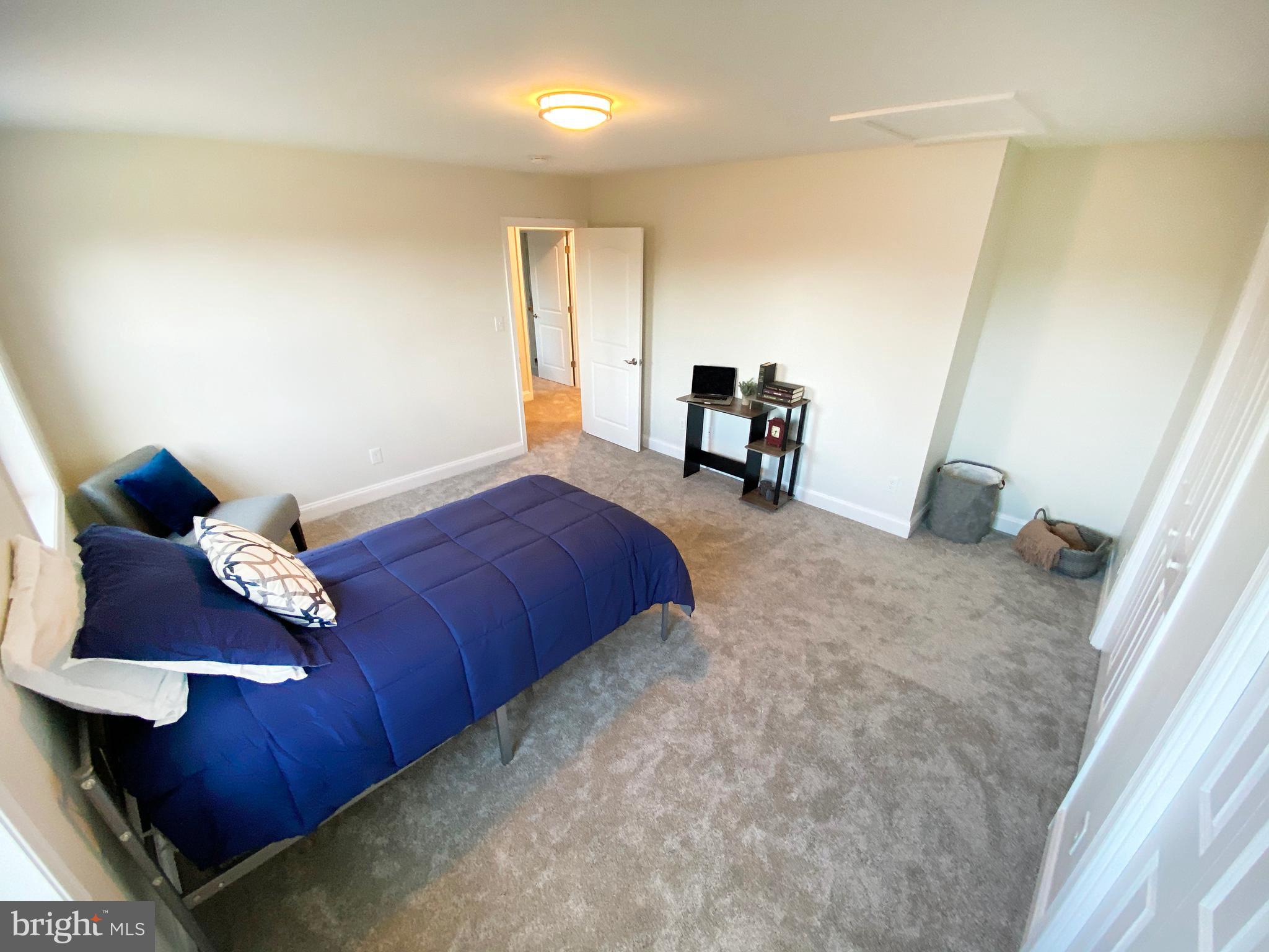 3797 Howellsville Road Front Royal, VA 22630 - Photo 39 of 66 a bedroom with a bed and a chair