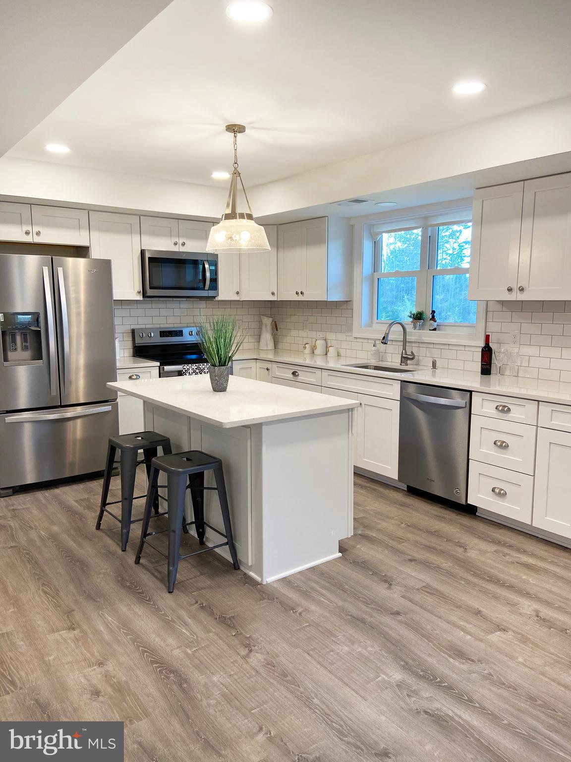 3797 Howellsville Road Front Royal, VA 22630 - Photo 7 of 66 a kitchen with stainless steel appliances a sink a stove a refrigerator cabinets and wooden floor