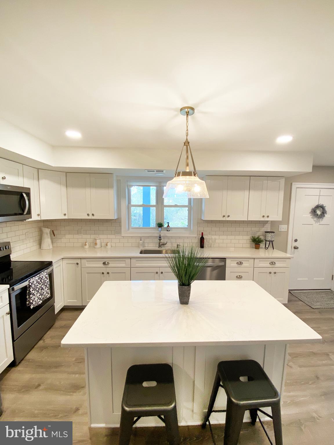 3797 Howellsville Road Front Royal, VA 22630 - Photo 8 of 66 a kitchen with a white cabinets and chairs