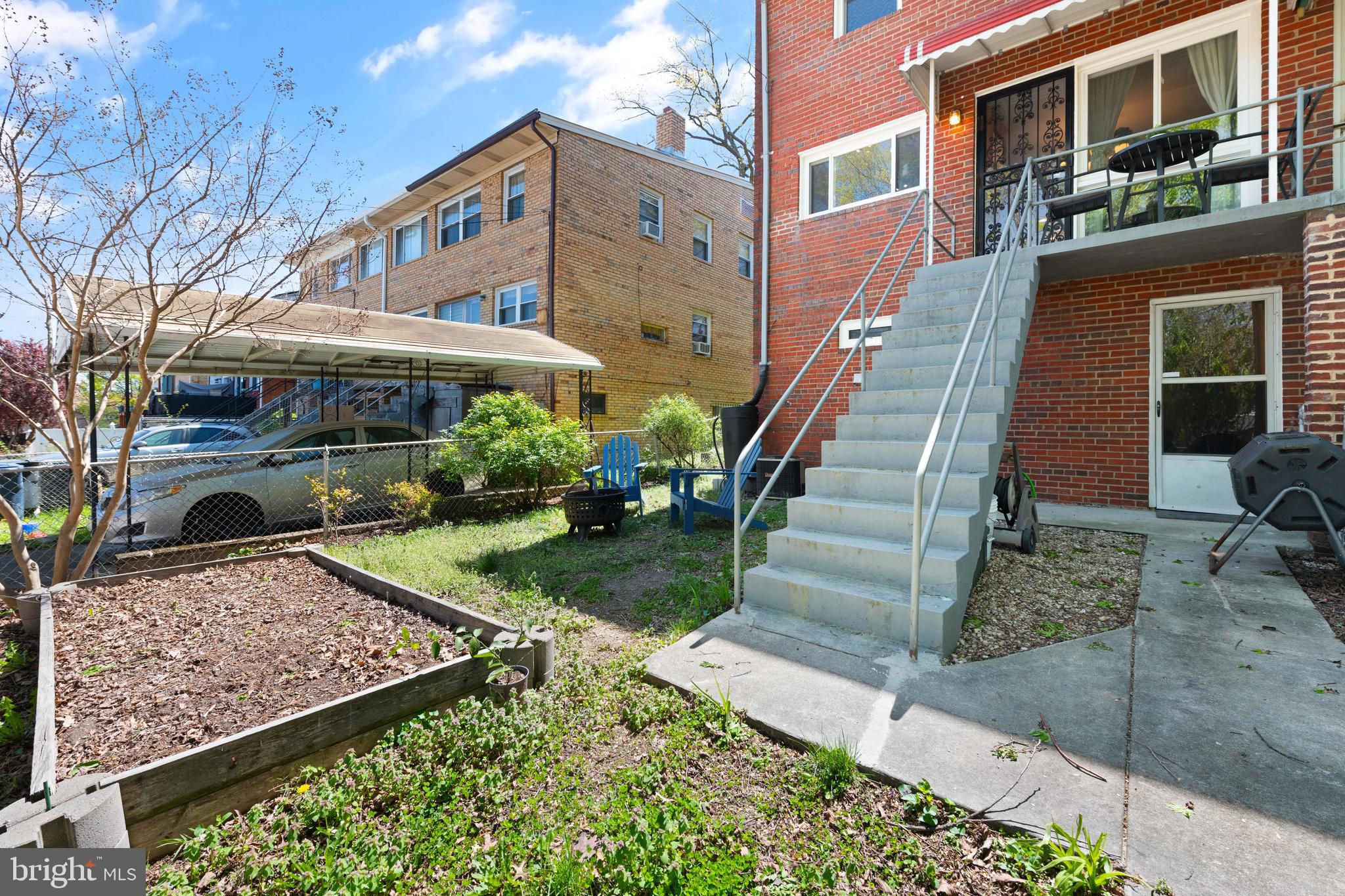 716 Delafield Street Northeast Washington, DC 20017 - Photo 13 of 32 a view of a building with a yard and large trees