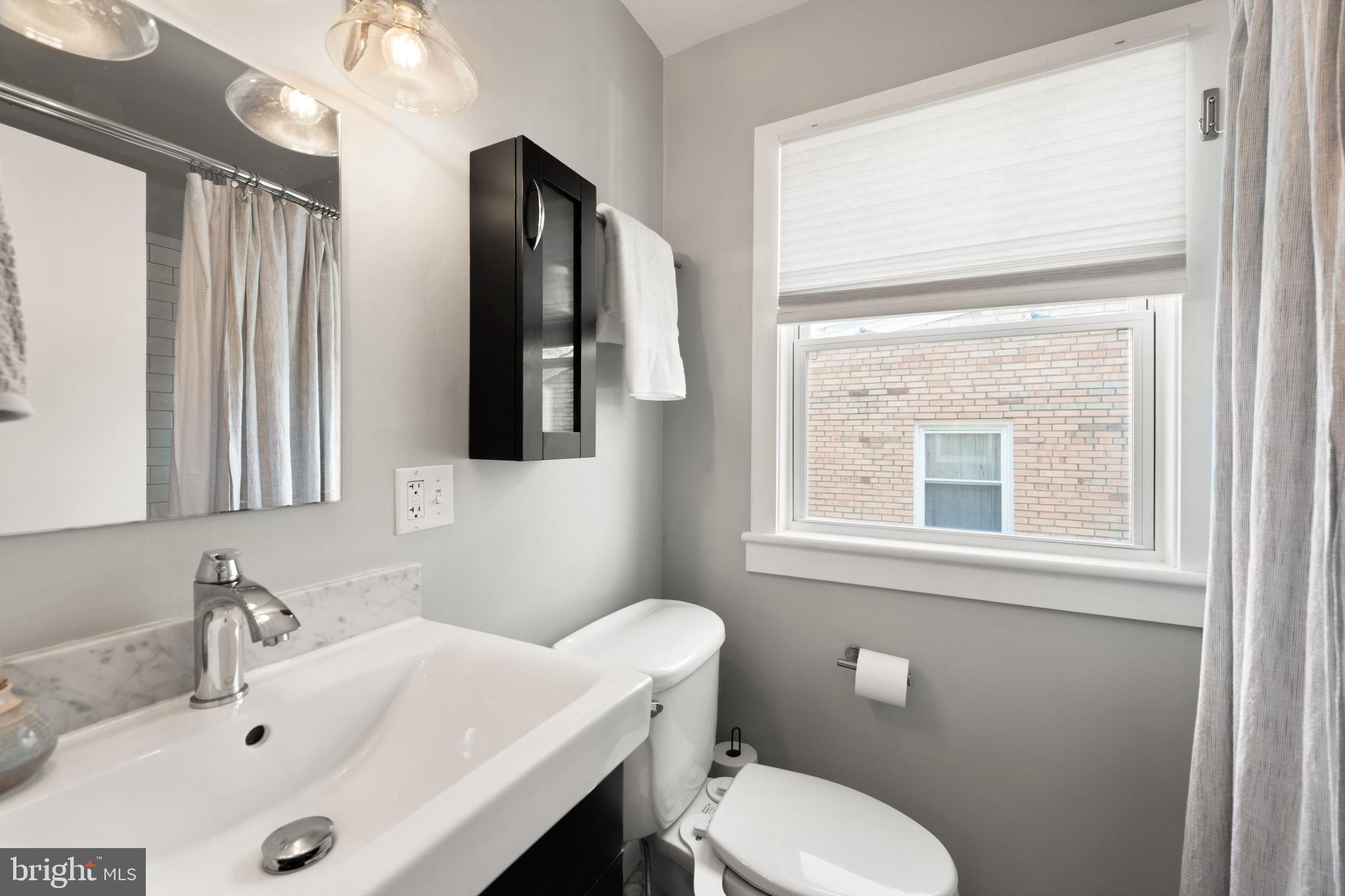 716 Delafield Street Northeast Washington, DC 20017 - Photo 18 of 32 a bathroom with a sink toilet and mirror