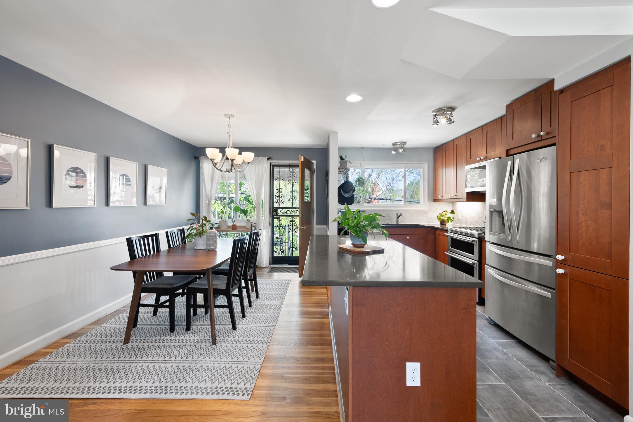716 Delafield Street Northeast Washington, DC 20017 - Photo 7 of 32 a view of a dining room with furniture a rug and wooden floor