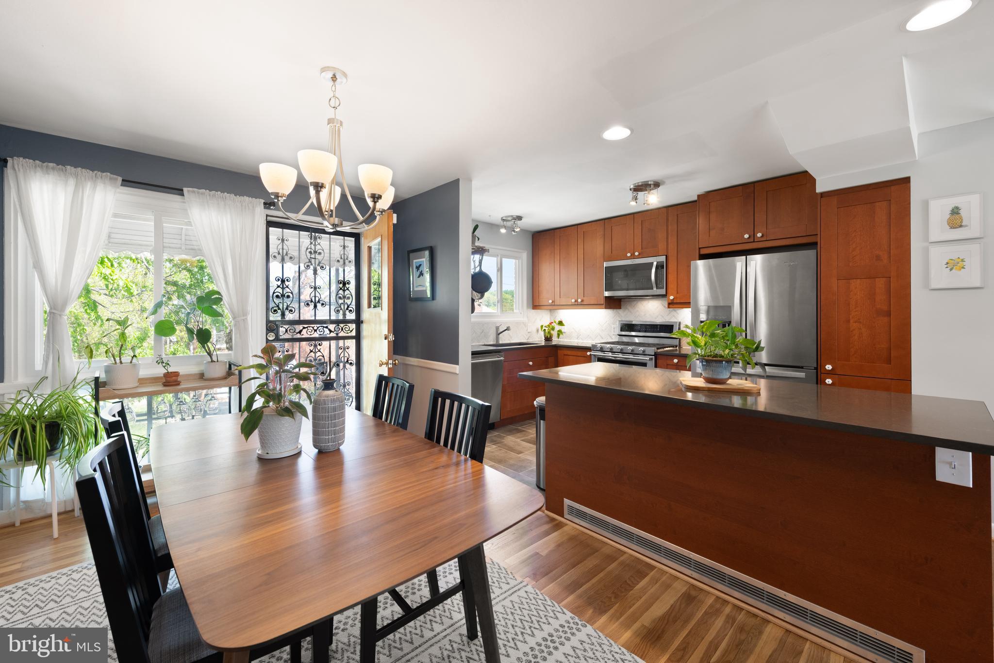 716 Delafield Street Northeast Washington, DC 20017 - Photo 8 of 32 a view of a dining room with furniture a chandelier and wooden floor