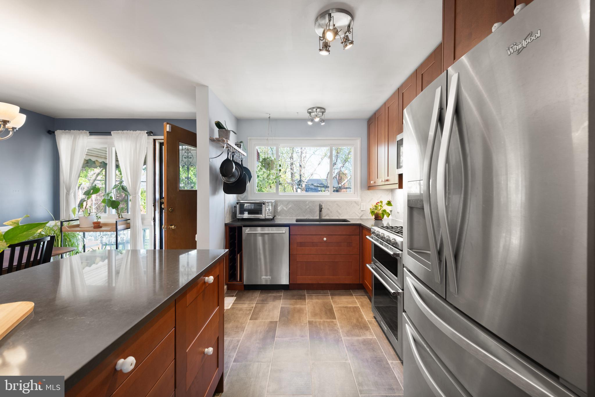 716 Delafield Street Northeast Washington, DC 20017 - Photo 9 of 32 a kitchen with stainless steel appliances granite countertop a refrigerator a stove and a sink